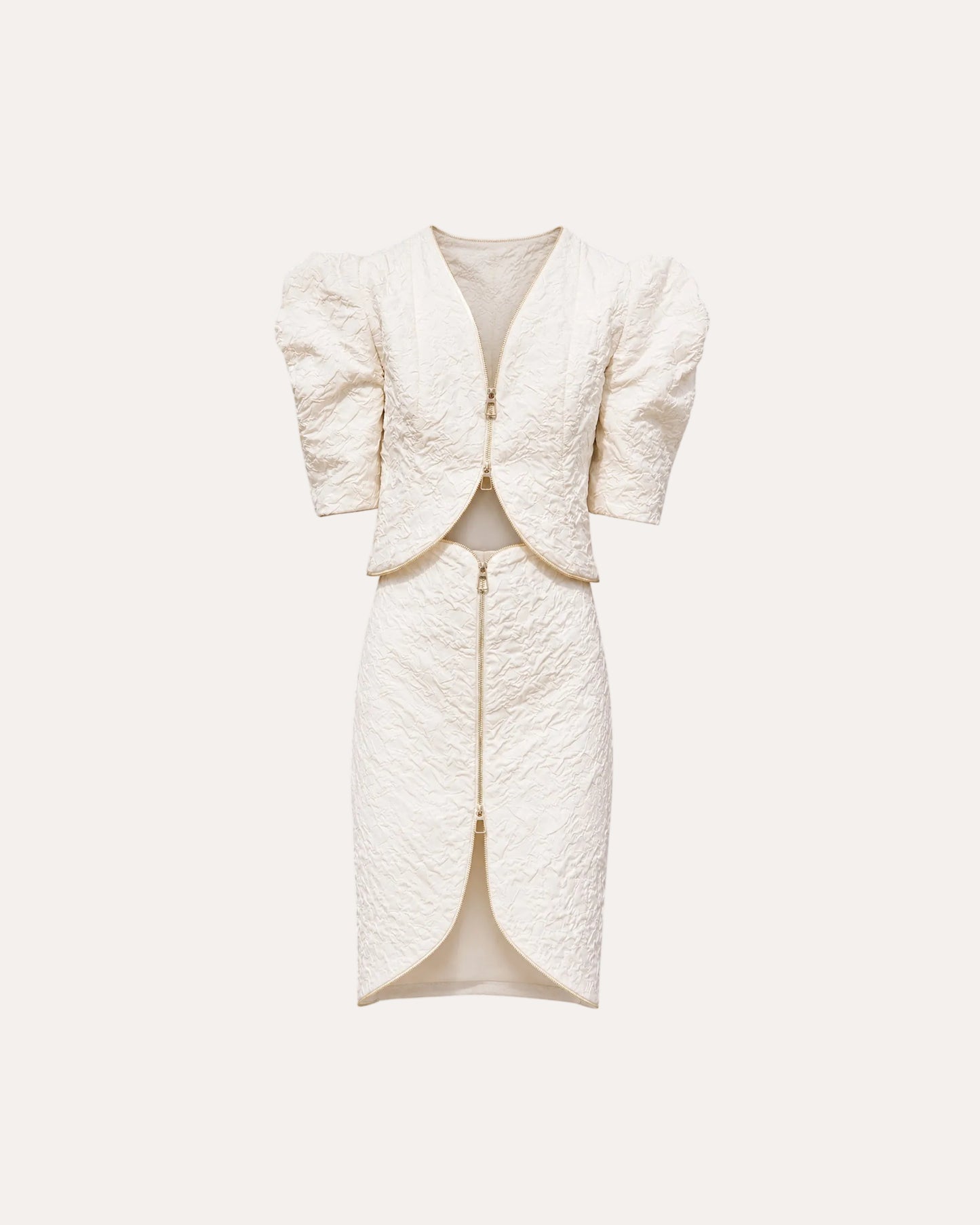 An off-white textured two-piece set featuring a short puff-sleeve jacket and a matching high-slit pencil skirt, both with gold-tone zippers, shown on a plain white background.