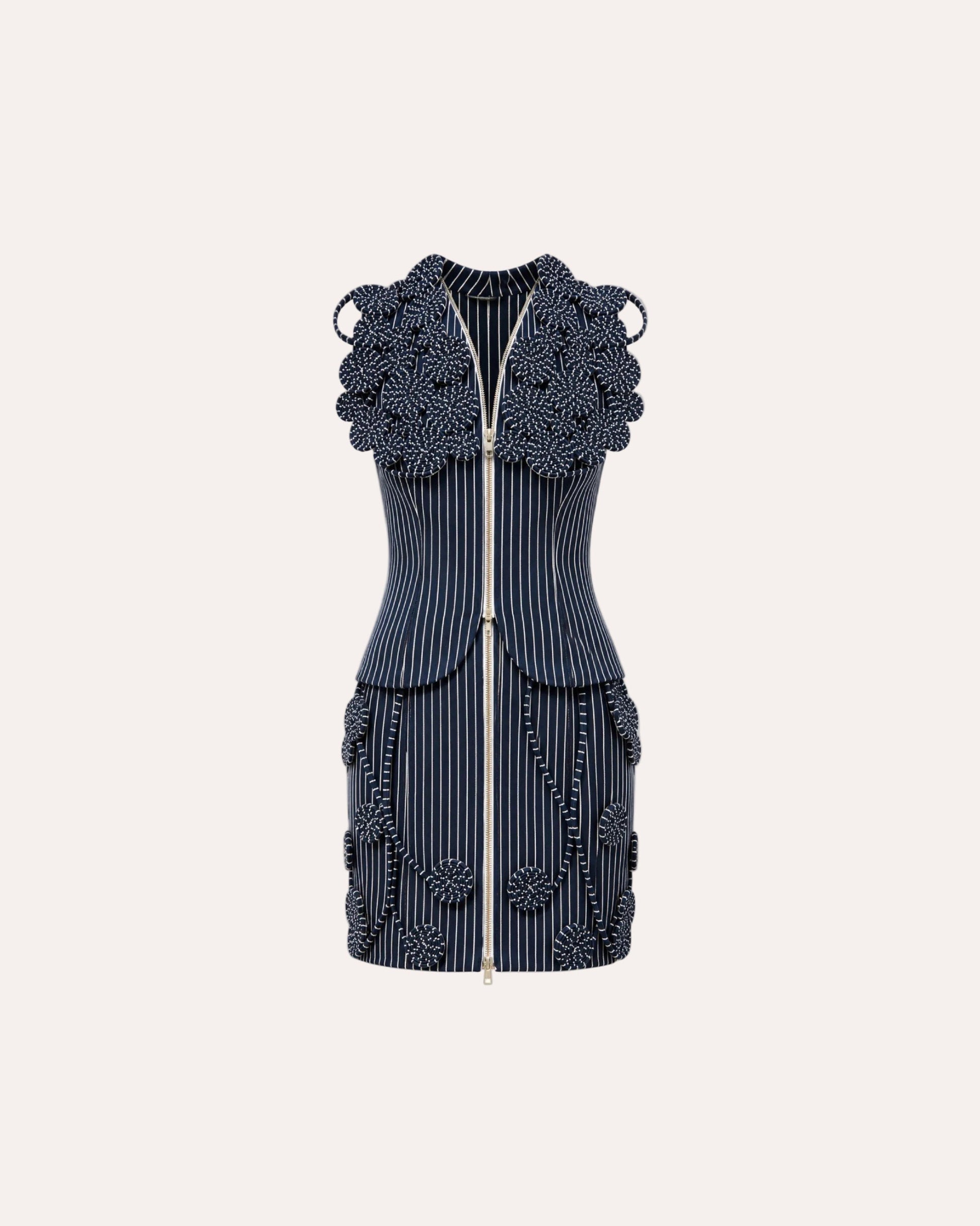A sleeveless navy blue and white pinstripe mini dress with intricate 3D floral beaded embellishments on the shoulders, waist, and hem, featuring a front zipper.