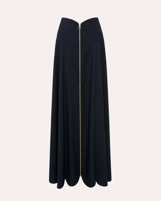 A black midi skirt with a sweetheart neckline and a prominent gold front zipper, shown against a light off-white background.